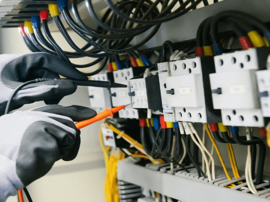 Technician testing an electrical panel